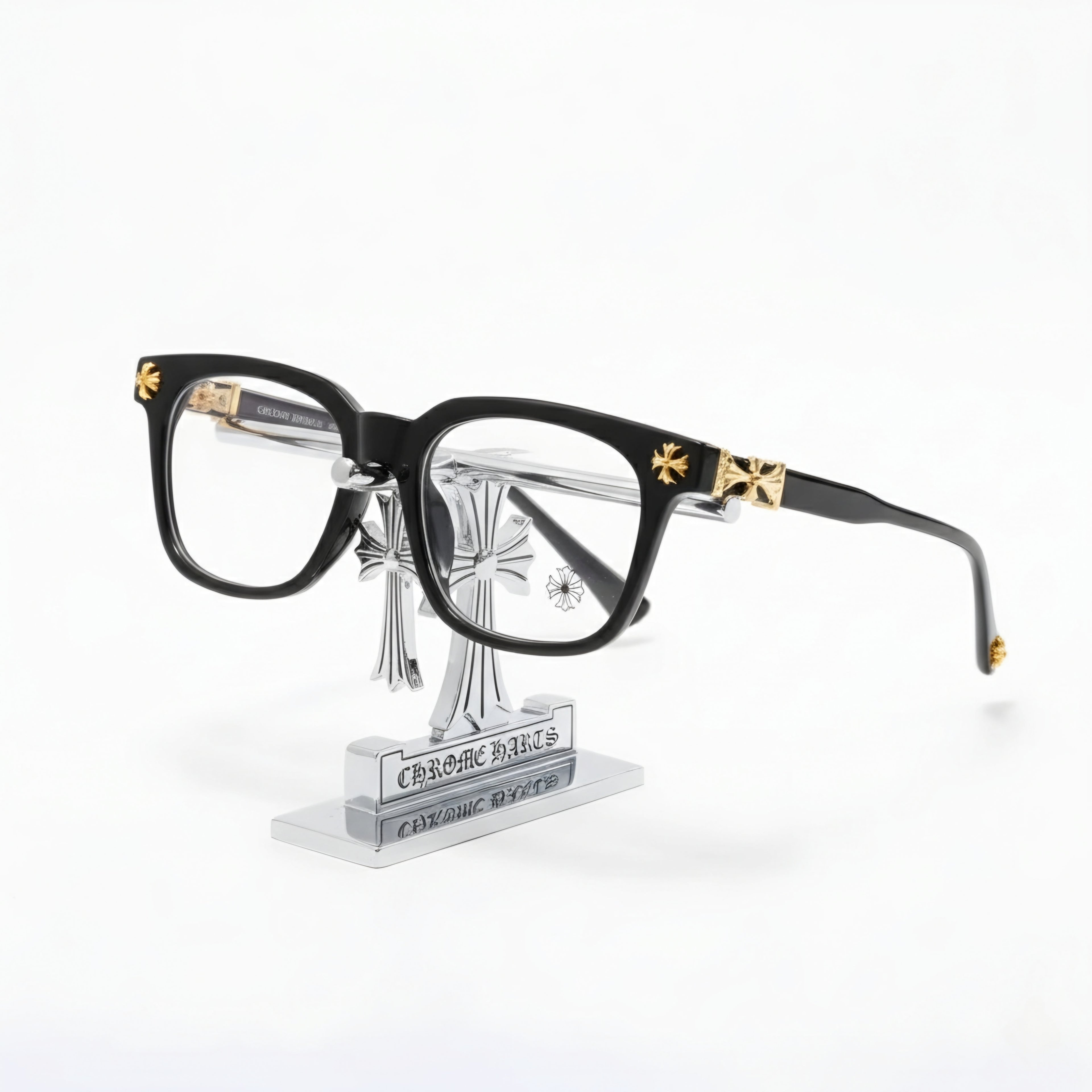 Shadow Gilded Square elegant black glasses with vintage gold-tone hardware on a display stand.